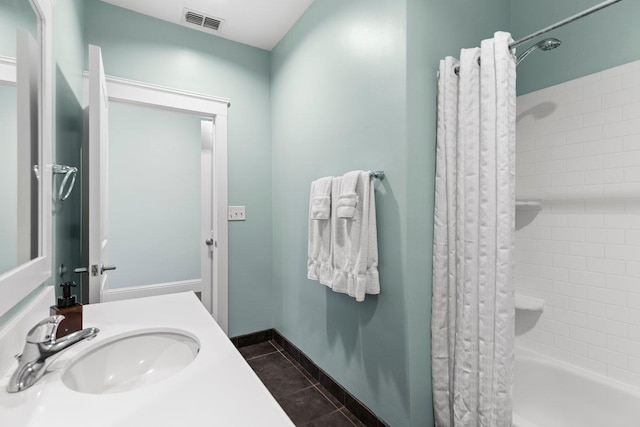 full bathroom featuring baseboards, visible vents, tile patterned floors, shower / bathtub combination with curtain, and a sink