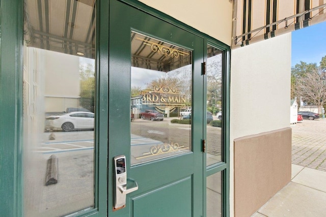 entrance to property featuring stucco siding