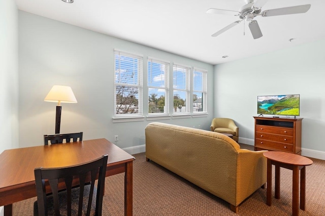 interior space with baseboards and a ceiling fan