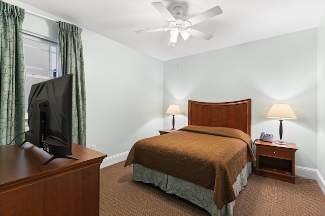 bedroom with ceiling fan, baseboards, and carpet flooring