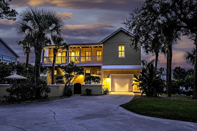 view of front of property featuring a garage and a balcony