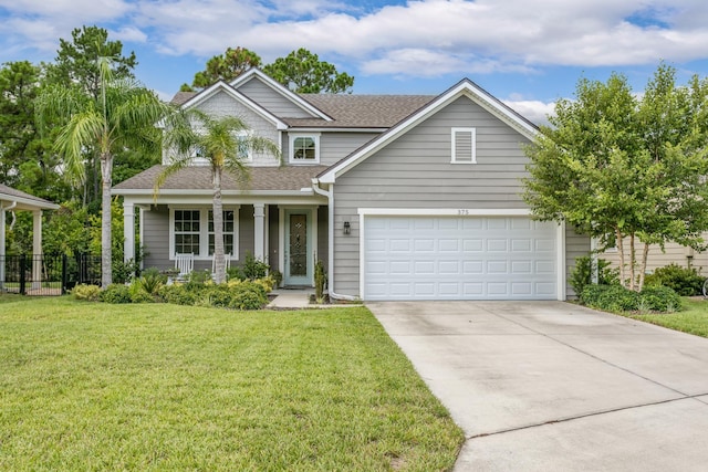 view of front of home featuring a porch, a garage, and a front lawn