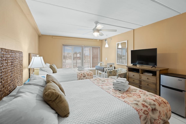 bedroom with ceiling fan and stainless steel fridge