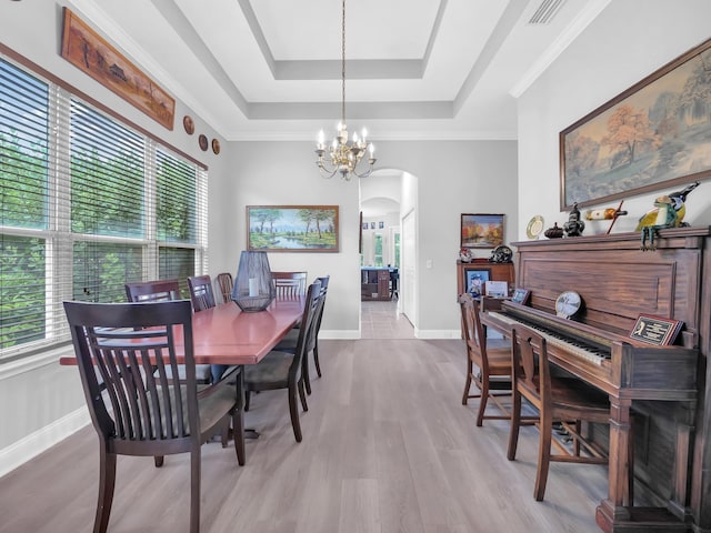 1201 Ellington Ct, Saint Augustine, FL 32084 - dining space featuring arched walkways, a raised ceiling, a chandelier, and wood finished floors
