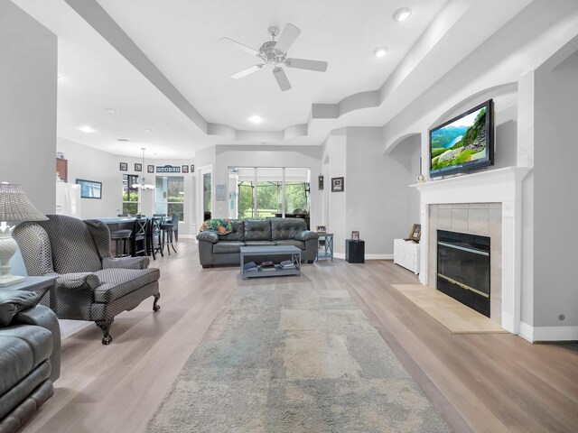 1201 Ellington Ct, Saint Augustine, FL 32084 - living room featuring light wood-type flooring, a fireplace, a raised ceiling, a ceiling fan, and recessed lighting
