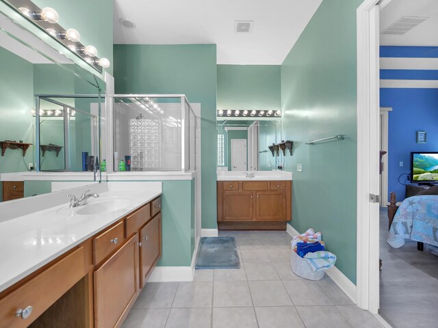 1201 Ellington Ct, Saint Augustine, FL 32084 - ensuite bathroom with a stall shower, two vanities, and tile patterned floors