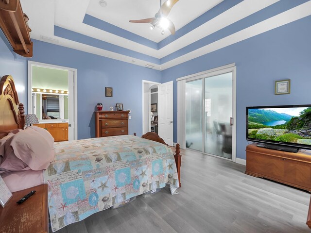 1201 Ellington Ct, Saint Augustine, FL 32084 - bedroom with wood finished floors, a raised ceiling, a closet, ceiling fan, and connected bathroom