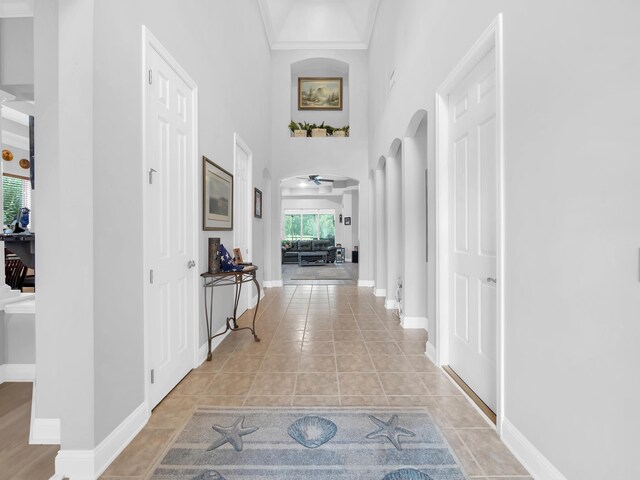 1201 Ellington Ct, Saint Augustine, FL 32084 - hallway with arched walkways, a high ceiling, and light tile patterned floors