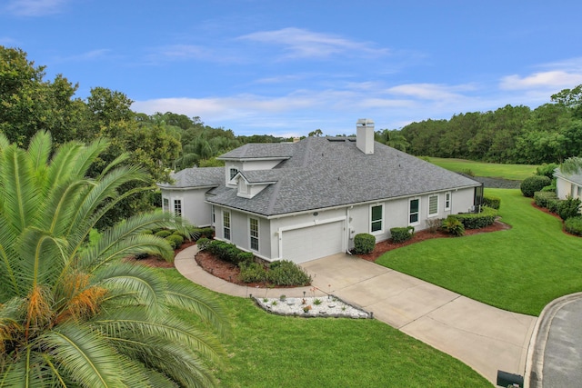 1201 Ellington Ct, Saint Augustine, FL 32084 - view of front of home with roof with shingles, stucco siding, concrete driveway, a front yard, and a chimney