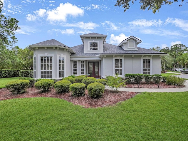 1201 Ellington Ct, Saint Augustine, FL 32084 - view of front of house featuring french doors, a front yard, stucco siding, and roof with shingles
