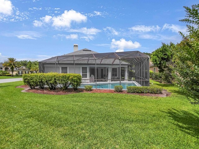 1201 Ellington Ct, Saint Augustine, FL 32084 - back of property featuring a yard, a chimney, and glass enclosure