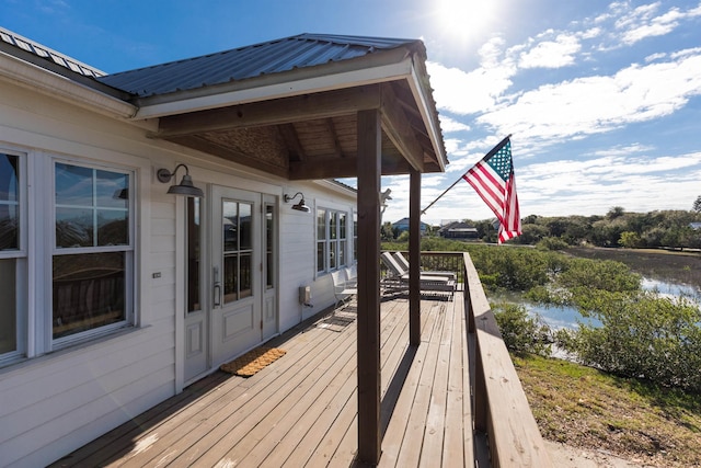 wooden deck featuring a water view