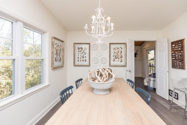 6698 Nassau St, Saint Augustine, FL 32080 - dining area with a chandelier and dark wood-style flooring