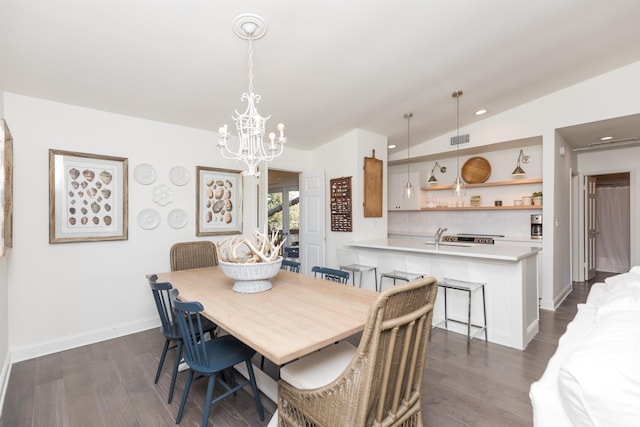 6698 Nassau St, Saint Augustine, FL 32080 - dining area featuring a chandelier, dark wood-type flooring, and vaulted ceiling