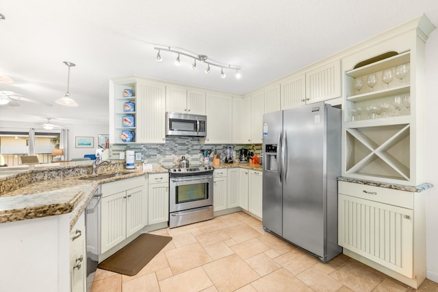 kitchen featuring stainless steel appliances, ceiling fan, decorative light fixtures, stone counters, and white cabinets