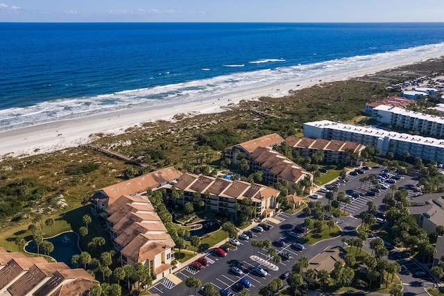 drone / aerial view featuring a water view and a beach view