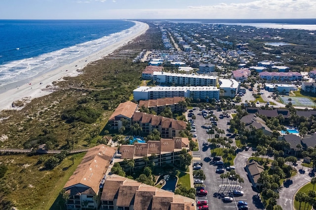 drone / aerial view featuring a beach view and a water view