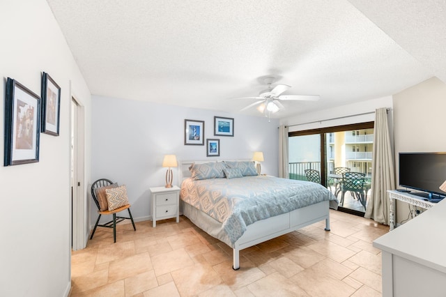 bedroom featuring access to exterior, ceiling fan, and a textured ceiling