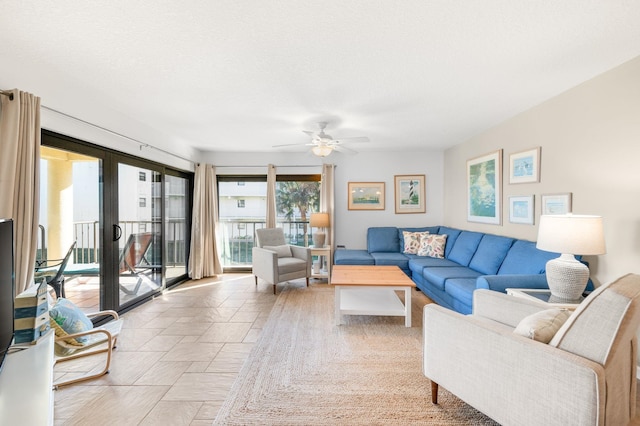 living room with french doors, a textured ceiling, and ceiling fan