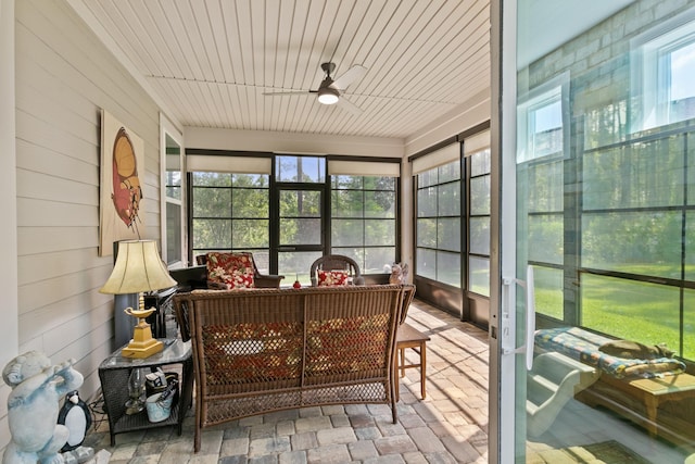 sunroom / solarium featuring ceiling fan and outdoor lounge area
