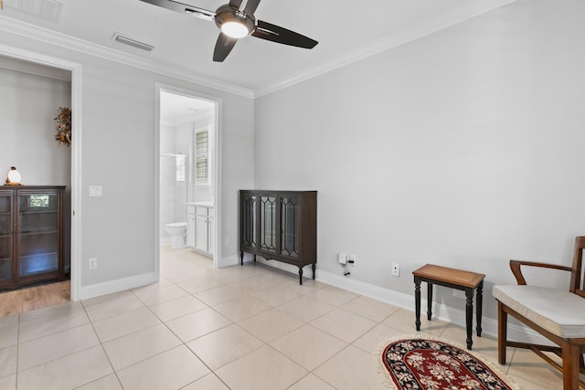 living area with visible vents, a ceiling fan, baseboards, and crown molding