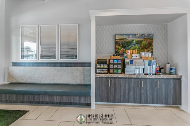 bar with light tile patterned floors and wallpapered walls