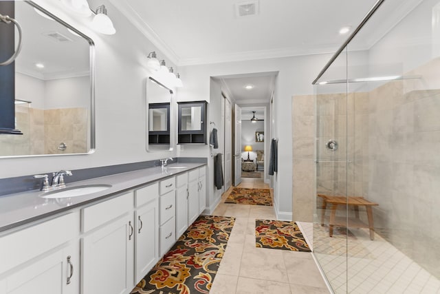 full bathroom with double vanity, visible vents, a shower stall, a sink, and ornamental molding