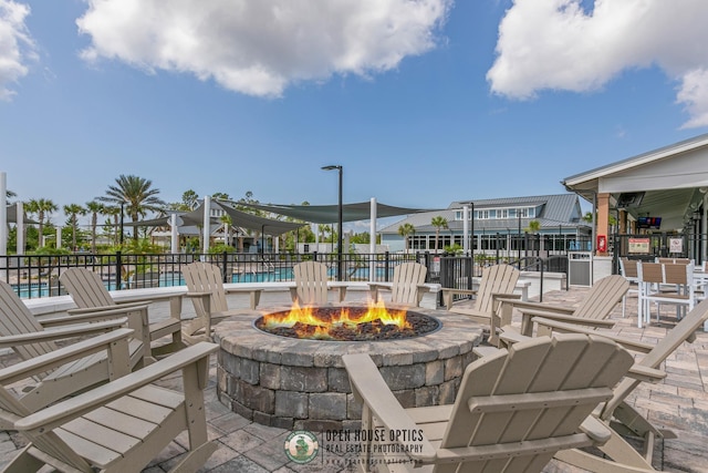 view of patio / terrace with a community pool and an outdoor fire pit