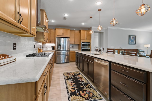kitchen featuring decorative backsplash, crown molding, appliances with stainless steel finishes, pendant lighting, and a sink
