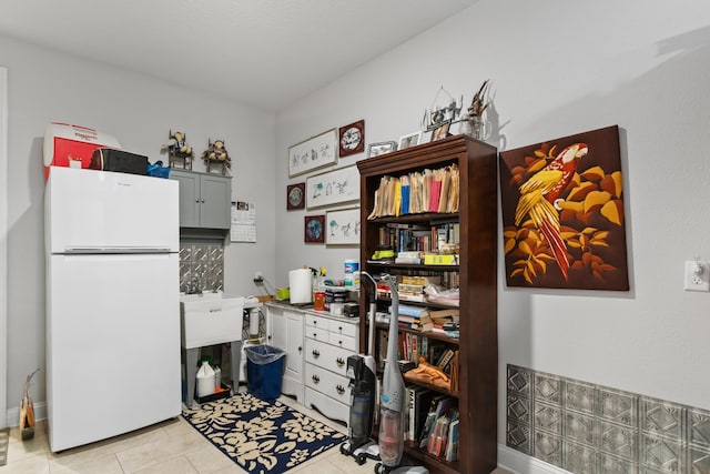 office space with a sink and light tile patterned flooring