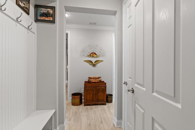 mudroom featuring baseboards, ornamental molding, wood tiled floor, and visible vents