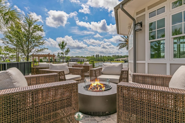 view of patio / terrace with an outdoor living space with a fire pit and a pergola