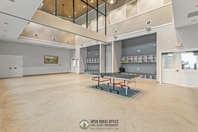 rec room featuring a high ceiling