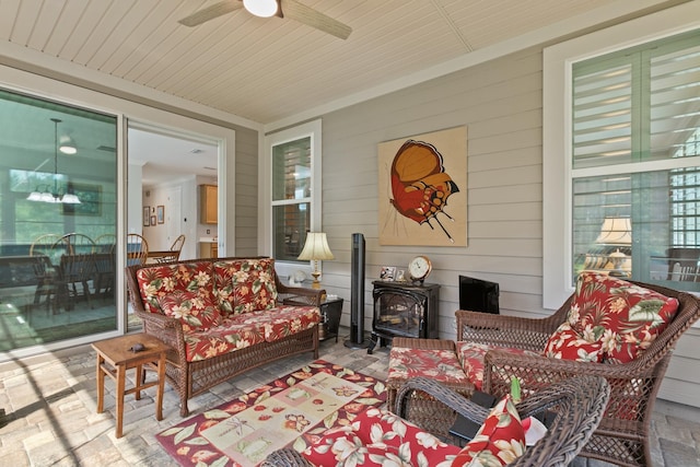 sunroom featuring a wood stove