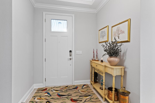 foyer with baseboards and ornamental molding