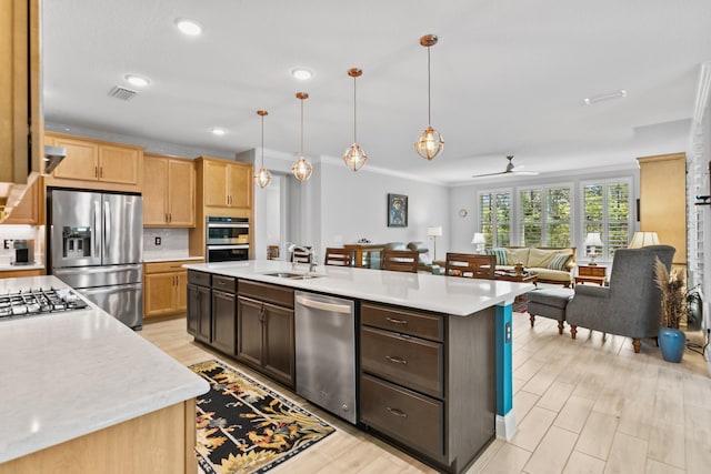 kitchen with visible vents, light countertops, a sink, and stainless steel appliances