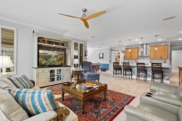 living area featuring crown molding, recessed lighting, ceiling fan, and visible vents