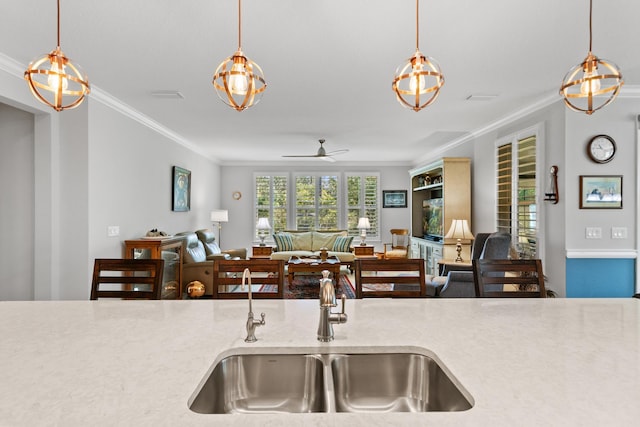 kitchen featuring a sink, crown molding, and open floor plan