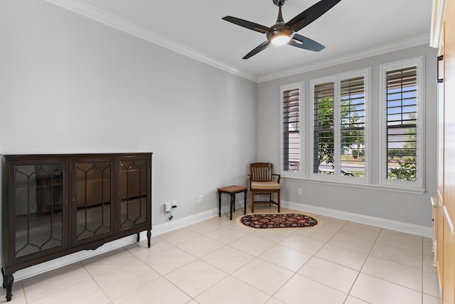 living area with crown molding, a ceiling fan, and baseboards