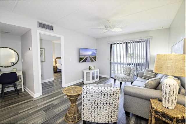 living room featuring a textured ceiling, dark hardwood / wood-style flooring, and ceiling fan