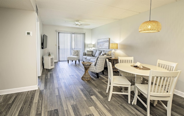 dining room with ceiling fan and dark wood-type flooring