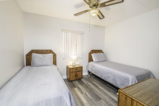 bedroom with dark hardwood / wood-style floors and ceiling fan