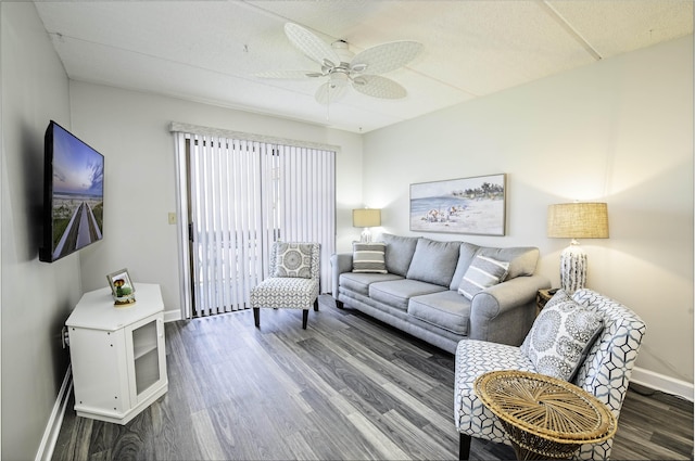 living room featuring dark hardwood / wood-style flooring and ceiling fan