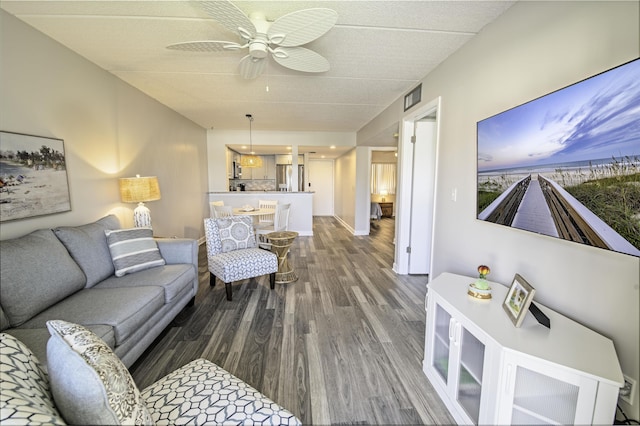 living room featuring ceiling fan and hardwood / wood-style flooring