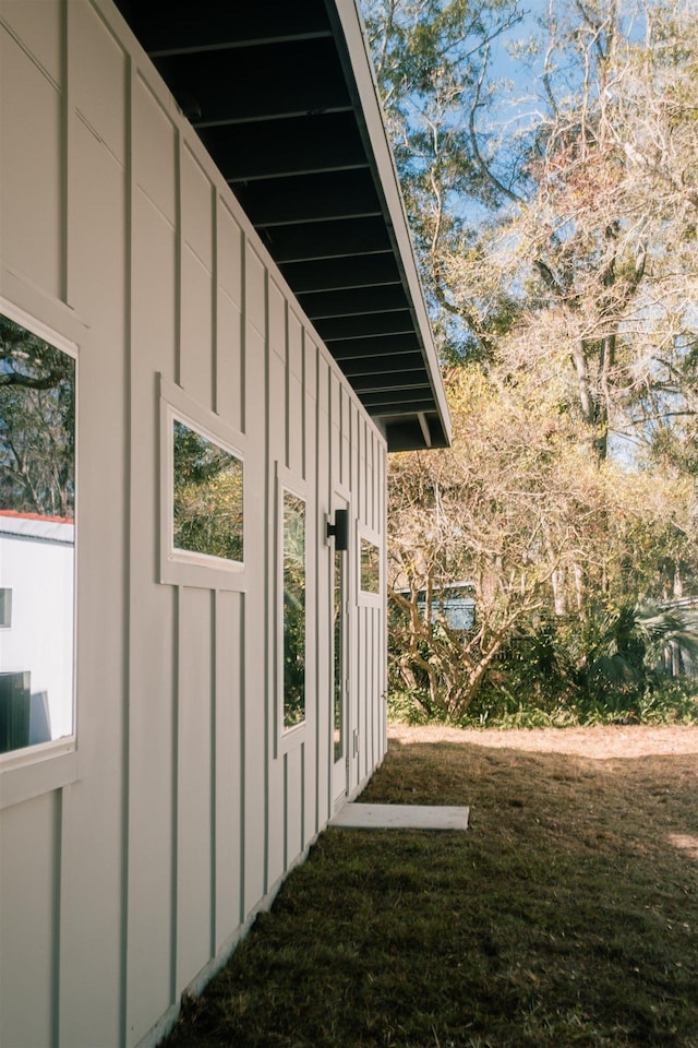 view of side of home featuring a lawn