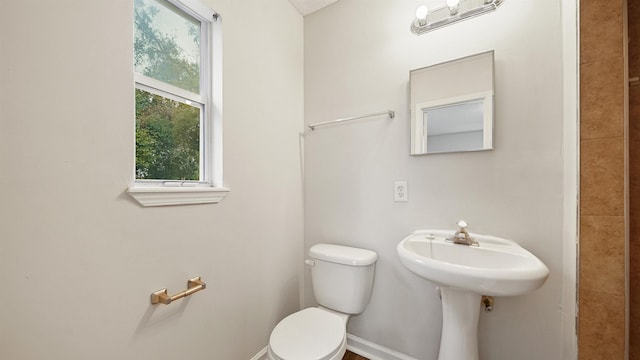 bathroom featuring toilet and baseboards