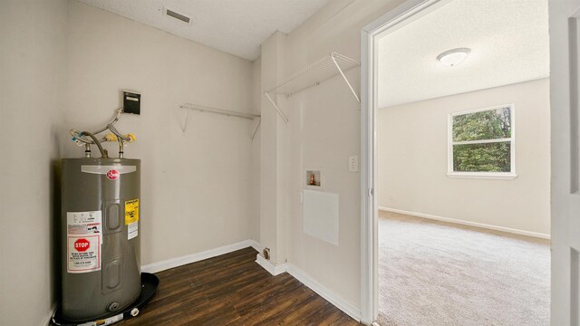 utility room featuring water heater and visible vents