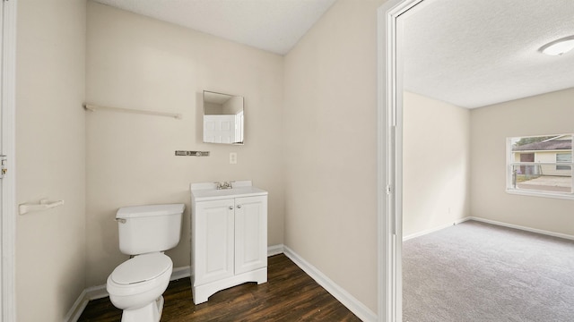 half bath with a textured ceiling, toilet, and baseboards