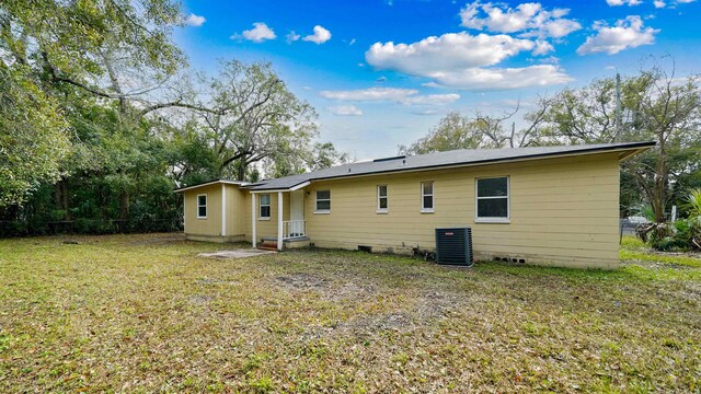 back of house with crawl space, a yard, fence, and central air condition unit