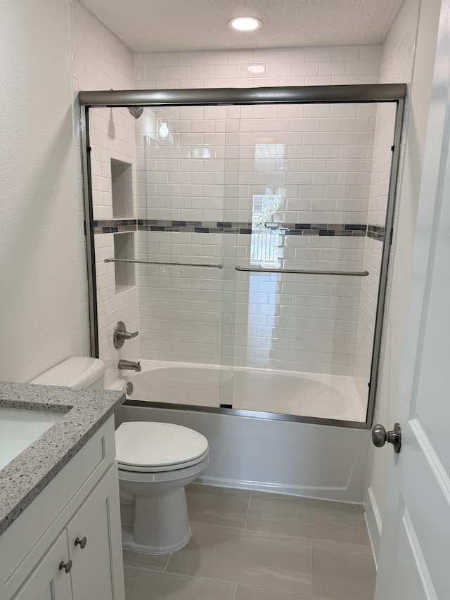 4913 Medoras Ave, Saint Augustine, FL 32080 - full bath with vanity, toilet, shower / bath combination with glass door, and tile patterned floors